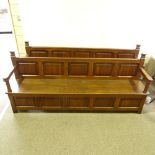 A pair of 19th century panelled oak settles, length 2.3m