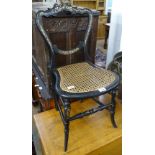 A Victorian ebonised and gilded side chair, with cane panelled seat and mother-of-pearl inset