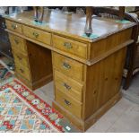 A polished pine twin-pedestal writing desk, with 9 fitted drawers, W120cm