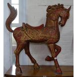A sectional painted and gilded wood sectional floor standing horse, with inset