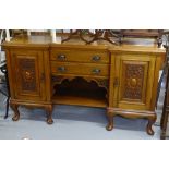 An Art Nouveau mahogany break-front sideboard, fitted with drawers and cupboards and stylised