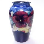 A Vintage Moorcroft blue ground vase with painted pansies design, repaired, height 12.5cm