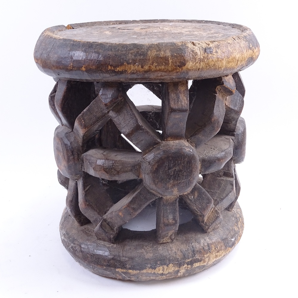An African Tribal carved and stained hardwood ceremonial seat, seat height 30cm