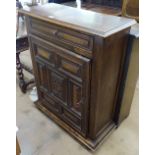 A Continental oak cabinet, single frieze drawer, and fielded carved and panelled door under, on