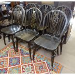 A set of 6 oak wheel-back dining chairs