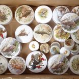 A quantity of pots with game bird, fish, and hunting scene lids