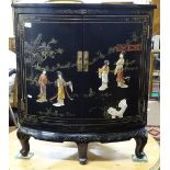 A Chinese design black lacquered low 2-door corner cupboard, with painted and applied figural