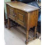 An Ipswich oak design sideboard of small size, with serpentine top, panelled cupboards under, raised