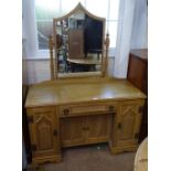 An Art Deco limed oak knee-hole dressing table, fitted with drawers and cupboards, W116cm