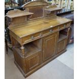 A late Victorian Arts and Crafts oak buffet, raised shelved back, with drawers and cupboards
