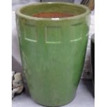 A green glazed terracotta garden plant pot, height 58cm