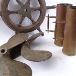 A carved wood brass-mounted ship's wheel, 2 cast-iron ship's propellers, and 2 trench art shell-case