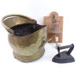A wall-mounted brass dinner bell, brass coal bin, and a flat iron (3)