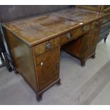 A mahogany and satinwood-banded knee-hole writing desk, fitted with 3 short drawers and cupboards