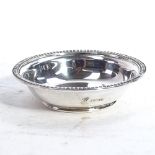 A small circular silver pin dish, with gadrooned edge, retailed by Garrard & Co Ltd