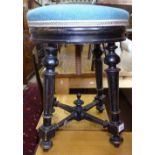 A Victorian ebonised and upholstered piano stool