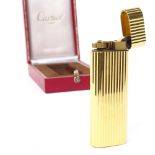 A Cartier gold plated cigarette lighter, model no. D55902, length 7cm, boxed