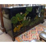 A Chinese design black lacquered sideboard, having 4 cupboard doors, and allover floral and bird