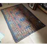 A red ground Afghan rug with symmetrical pattern and border, 190cm x 127cm