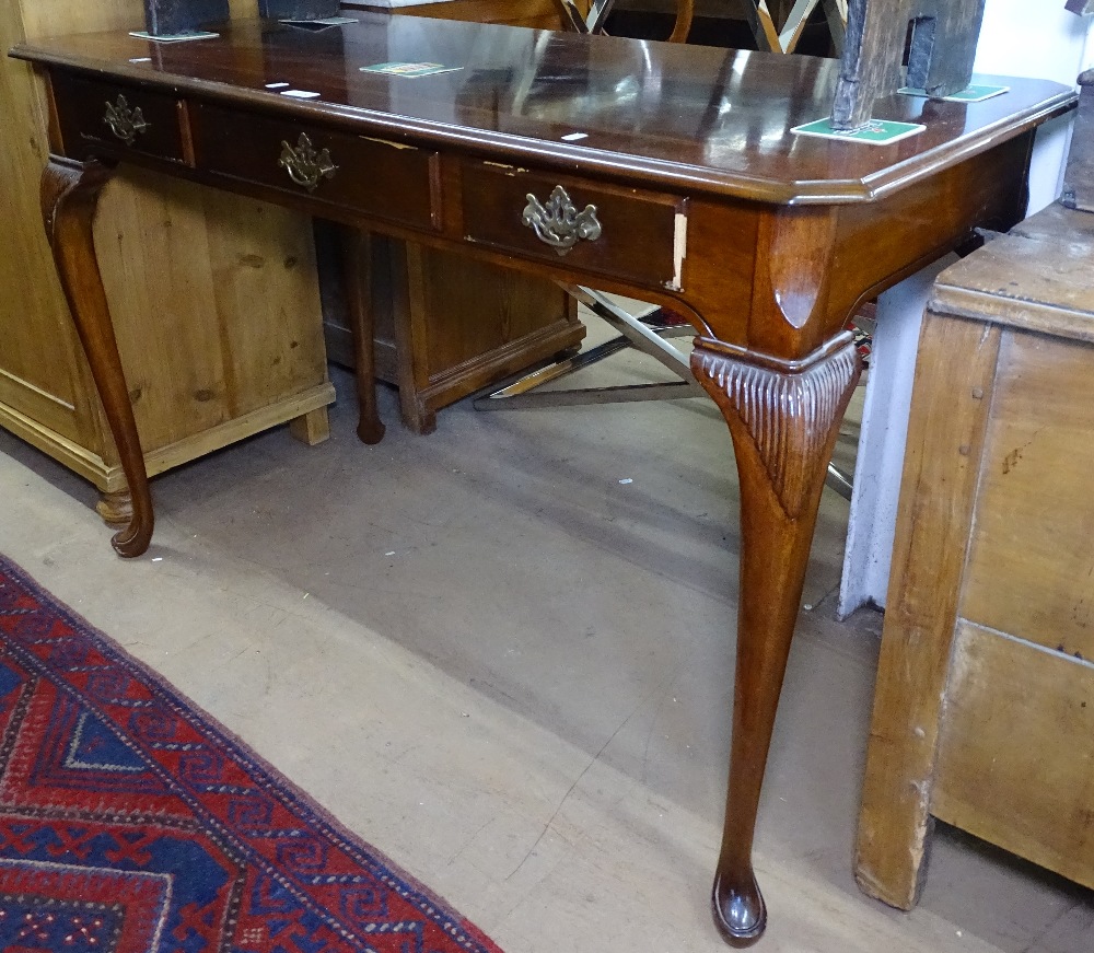 A reproduction mahogany console table with 3 frieze drawers, on cabriole legs, W122cm