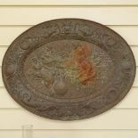 A 19th century oval brass plaque, relief embossed tavern and dragon decoration, length 63cm