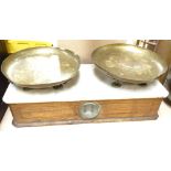 An Antique set of scales, stamped brass plates with white marble top and oak case, case length 57cm