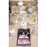 A collection of Victorian porcelain Pastille Burner Cottages, and a figure and book