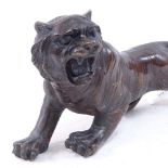 An Oriental bronze tiger sculpture, unsigned, length 30cm