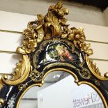 A modern ornate black lacquered and gold painted shaped wall mirror, overall height 107cm