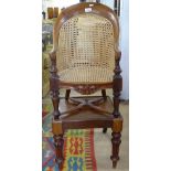 A Victorian child's wicker panelled chair, on associated stand