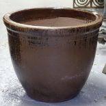 A brown glazed terracotta garden pot
