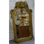 A modern ornate gilt-gesso framed wall mirror, 92cm