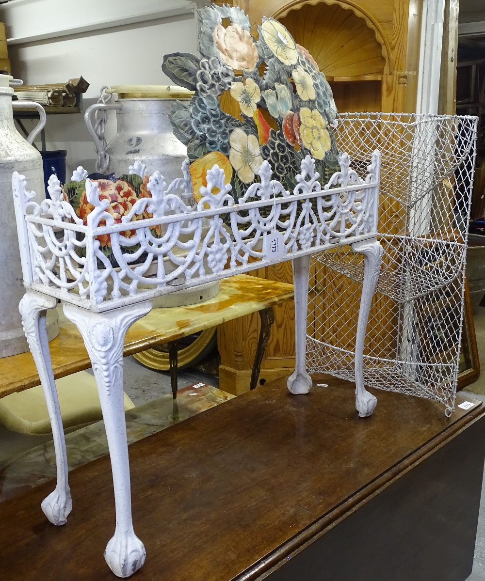 A rectangular pierced wrought-iron plant stand, a 3-tier wire mesh kitchen stand, a painted floral
