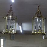 A pair of brass-framed circula 3-branch light fittings, length not including chain 53cm