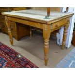 An Antique plank-top pine kitchen table with end frieze drawer, on baluster legs, L110cm