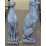 A pair of modern concrete garden statues, a study of seated hounds