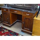 An Edwardian mahogany knee-hole writing desk, with fitted drawers and cupboards, W130cm