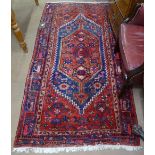A red ground wool Beluchi design rug, 205cm x 110cm