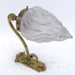 A 19th century brass wall-mounted light fitting, frosted glass flame design shade, plate bracket