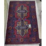 A red ground Beluchi rug, 142cm x 87cm