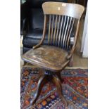 An early 20th century oak swivel desk chair