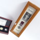 An Elliott speed indicator, Swales commemorative Victoria Cross, and an Ultimate JFK Half Dollar