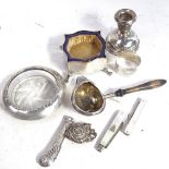 A small silver candlestick, silver-mounted ashtray, silver napkin ring, trinket box, a side-