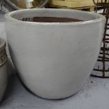 A large green glazed terracotta circular garden pot, W70cm, H58cm