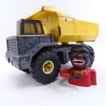 A Hasbro Tonka Toy tinplate tipper truck, and a novelty cast-iron money bank (2)