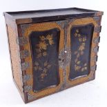 A Japanese Meiji Period ebonised and gilded wood table-top cabinet of drawers, caned side panels