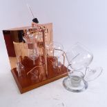 A Destil & Co of Mississippi copper distilling set up, and a cased Brandy balloon with warming stand
