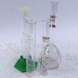 A collection of various scientific laboratory equipment, including measuring cylinders, conical