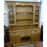 A polished pine 2-section kitchen dresser, with fitted drawers and cupboards, W162cm, H210cm