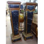 A pair of Egyptian Revival style pedestals, of tapered form, walnut-framed with applied white veined